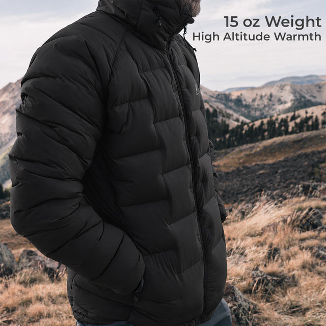 A man wearing a black 15 oz puffer jacket in an outdoor mountain landscape, with text overlay reading '15 oz Weight High Altitude Warmth'.