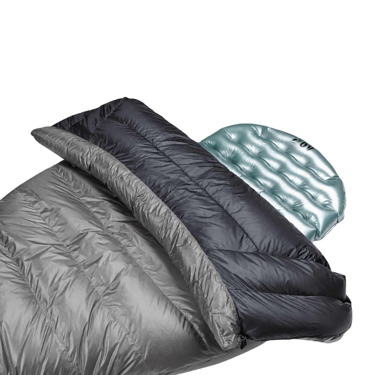 Close-up view of the black 40 degree Outdoor Vitals StormLoft Down TopQuilt pulled down to reveal its soft inner lining, paired with an inflatable sleeping pad setup.