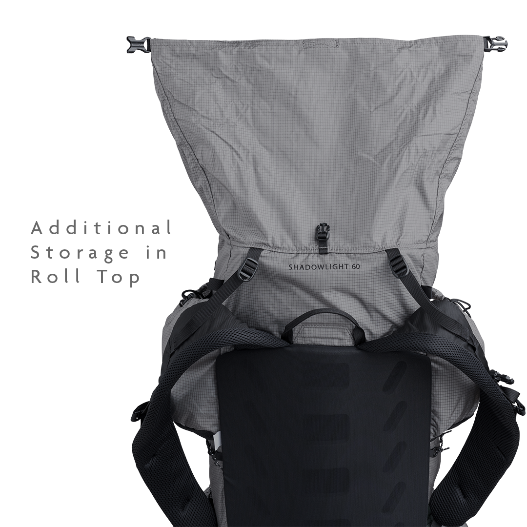 Rear view of the Shadowlight 60 backpack with roll-top closure open, showing main compartment expansion capacity.