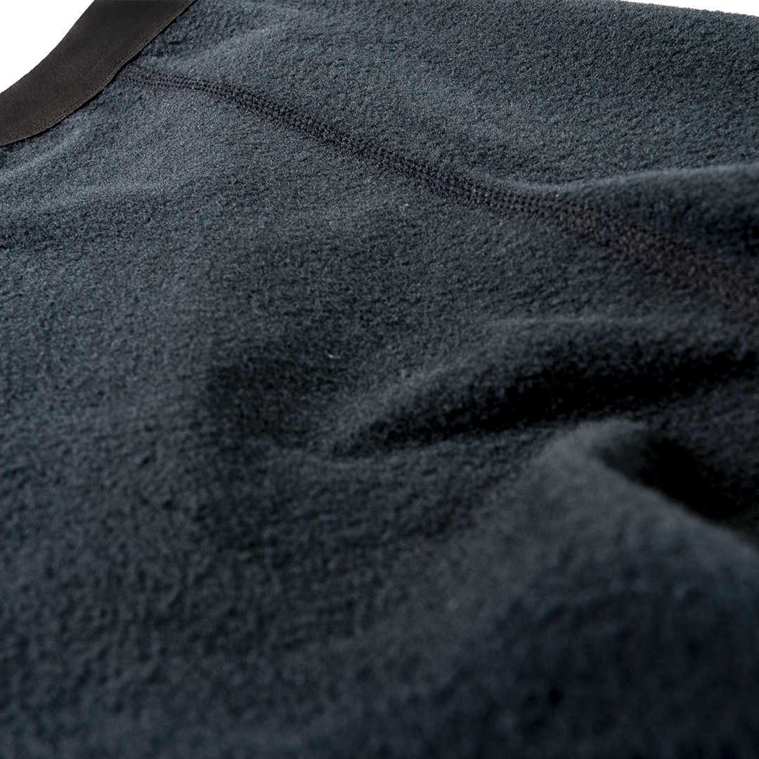 Close-up shot showing the soft fleece interior texture, elastic waistband, and flatlock seam stitching of Outdoor Vitals Highline Thermal Leggings.