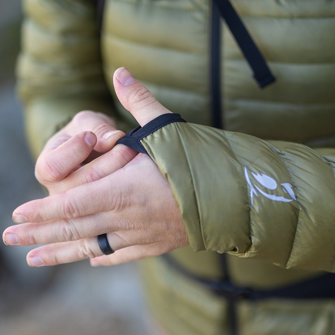 Close-up of a person using the integrated thumbhole loop on the sleeve cuff of a NovaUL down jacket.