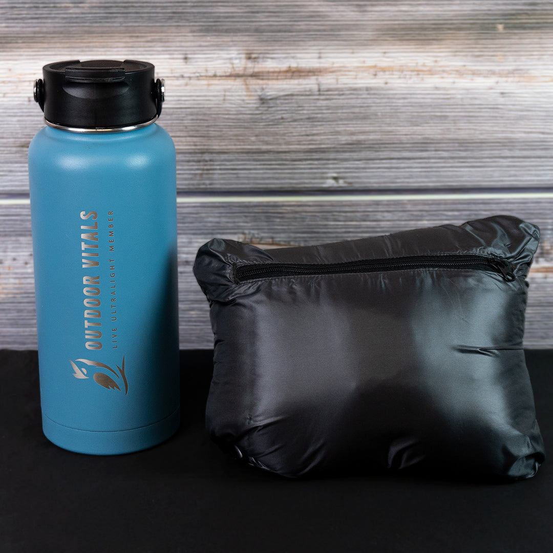 Packed NovaUL jacket beside a water bottle for size comparison