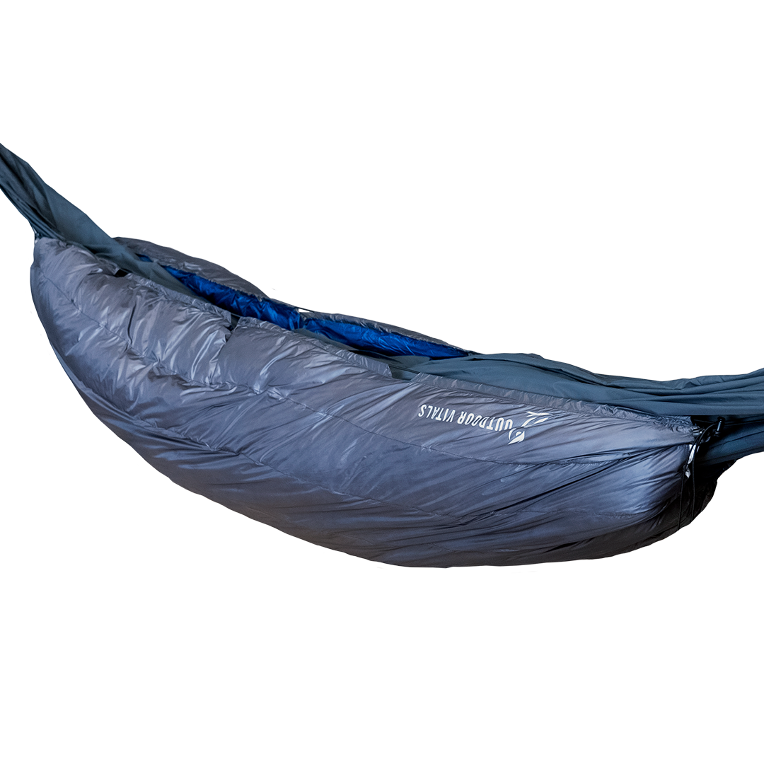 Side profile view of the Outdoor Vitals StormLoft 0°-30°F Down UnderQuilt attached beneath a hammock, highlighting the brand logo and draft baffles.