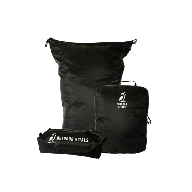 Product shot featuring Outdoor Vitals ultralight travel organization accessories, including a dry bag, a packing cube, and a zippered dopp kit pouch.
