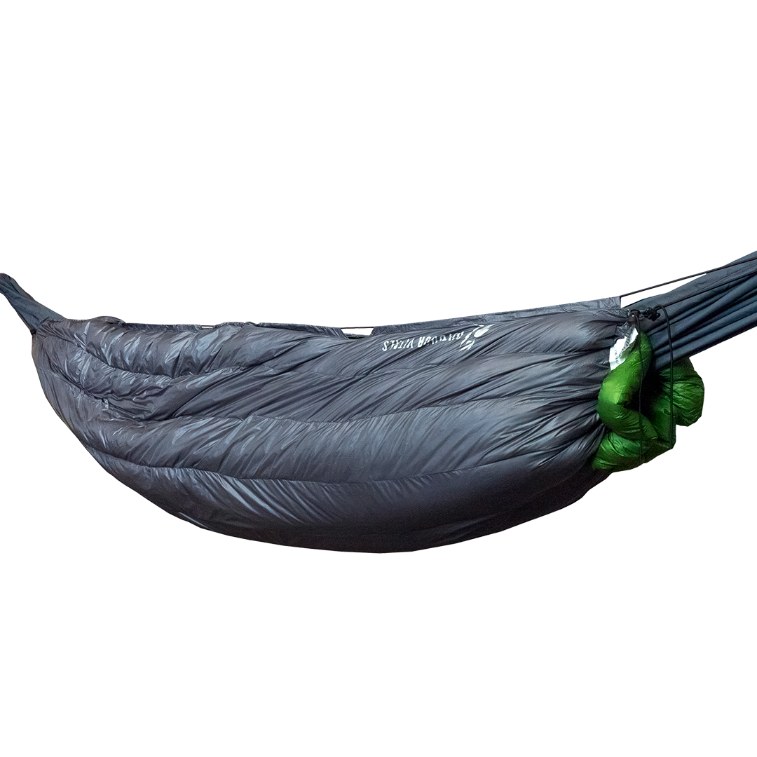Outdoor Vitals StormLoft Down UnderQuilt suspended beneath a camping hammock, showing its contoured shape and longitudinal insulation baffles.