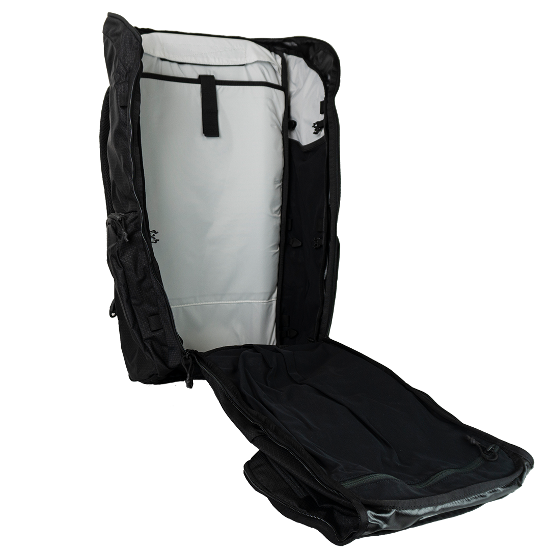 Fully opened main compartment of the Outdoor Vitals KotaUL Ultralight Travel & Adventure Backpack, displaying a clamshell zipper design, light-colored contrast lining, and a hydration bladder sleeve with a secure attachment loop.