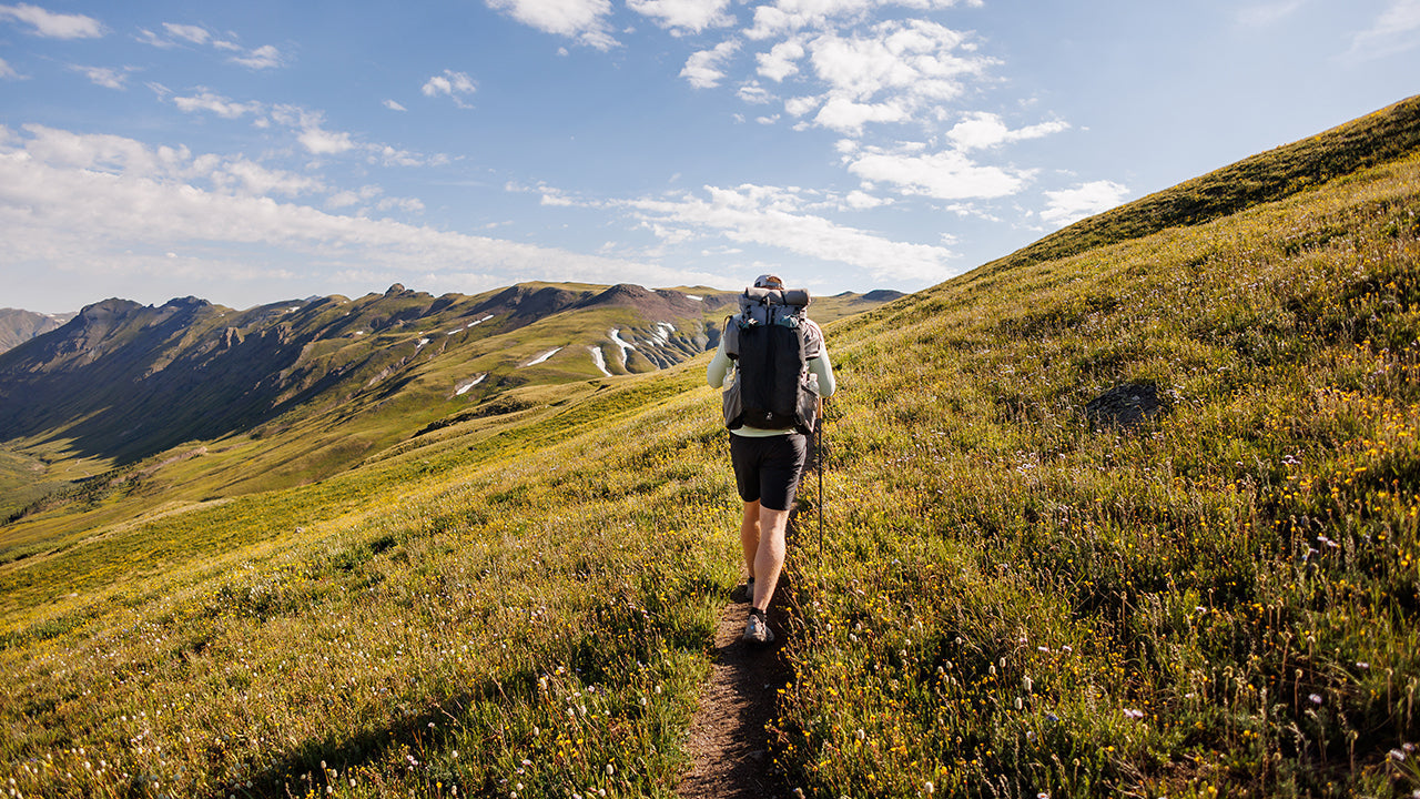 hiker on high alpine mountain side