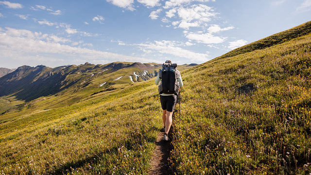 hiker on high alpine mountain side
