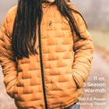 A person wearing a quilted mustard-yellow puffer jacket outdoors, with text overlay on the right reading '11 oz, 3 Season Warmth, 900 Fill Power Muscovy Down'.