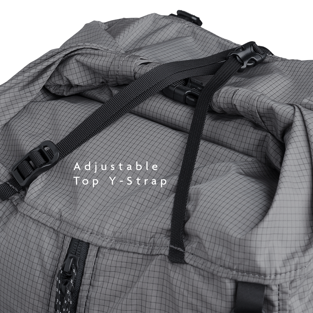 Close-up of the Outdoor Vitals Shadowlight backpack’s roll-top closure with adjustable top strap and buckle for secure compression.