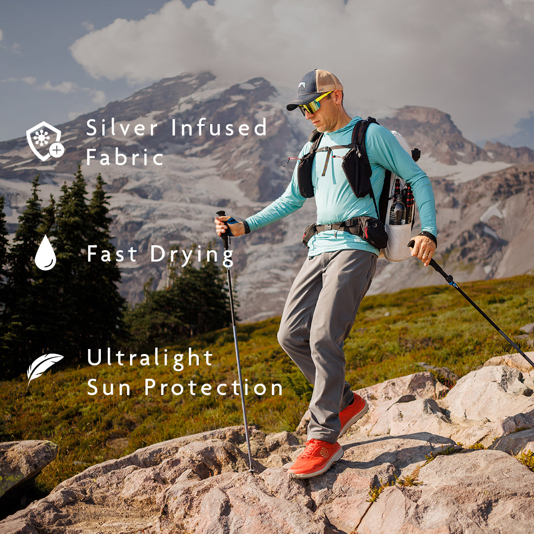 man wearing ultralight sun hoodie on alpine summit