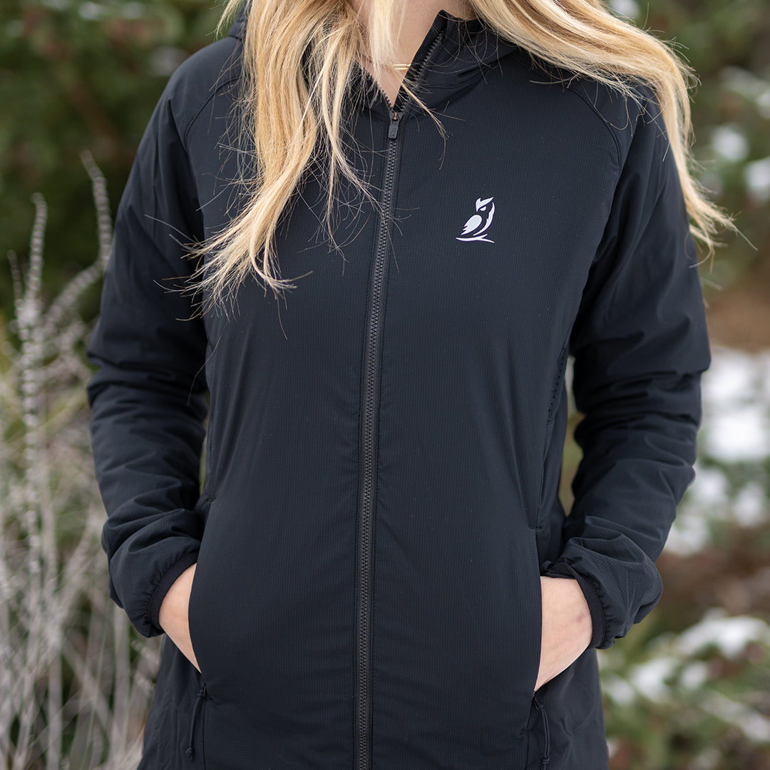 Woman wearing the Women's Outdoor Vitals Vario Jacket with hands in the zippered pockets