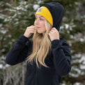 Woman wearing full zip hooded jacket for backpacking on winter