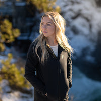 Woman wearing the Women's Outdoor Vitals Vario Jacket in a mountain landscape