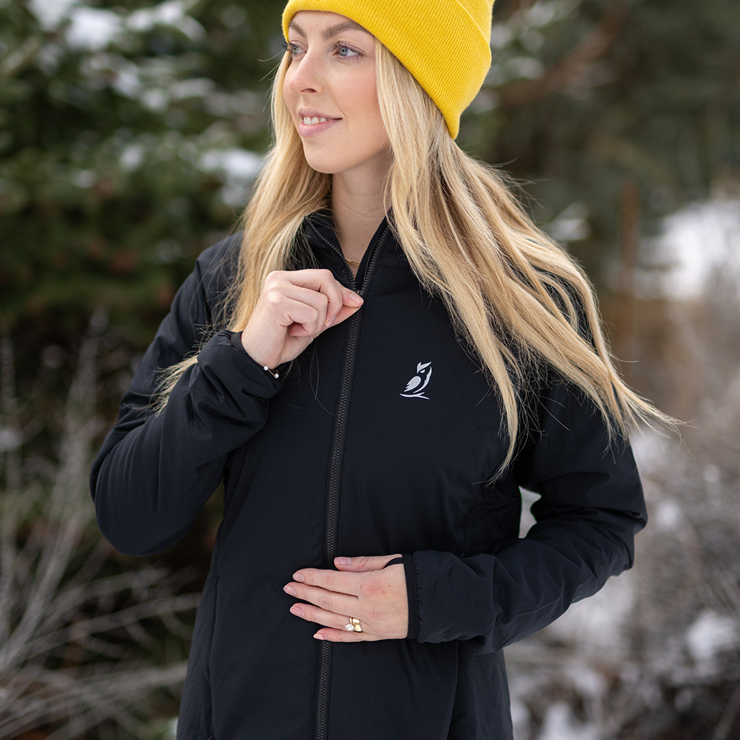 Woman wearing full zip hooded jacket for backpacking on winter