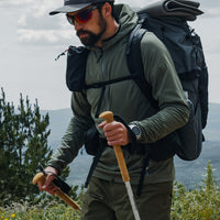 close side view of fleece hoodie on man while he's hiking