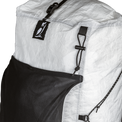 Close-up view of the upper front panel of the Outdoor Vitals CS40 Ultra Backpack, showing the owl logo tab, roll-top compression strap buckle, front mesh pocket, and side cord attachment points.