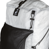 Close-up view of the upper front panel of the Outdoor Vitals CS40 Ultra Backpack, showing the owl logo tab, roll-top compression strap buckle, front mesh pocket, and side cord attachment points.