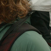 Close-up view of the padded shoulder strap and load lifter on the Outdoor Vitals CS40 Ultra Backpack, showcasing the breathable mesh padding and durable webbing construction.
