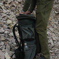 side view of men's hiking pants in rocky peak environment