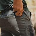 close view of man unzipping rear pocket on jogger pants