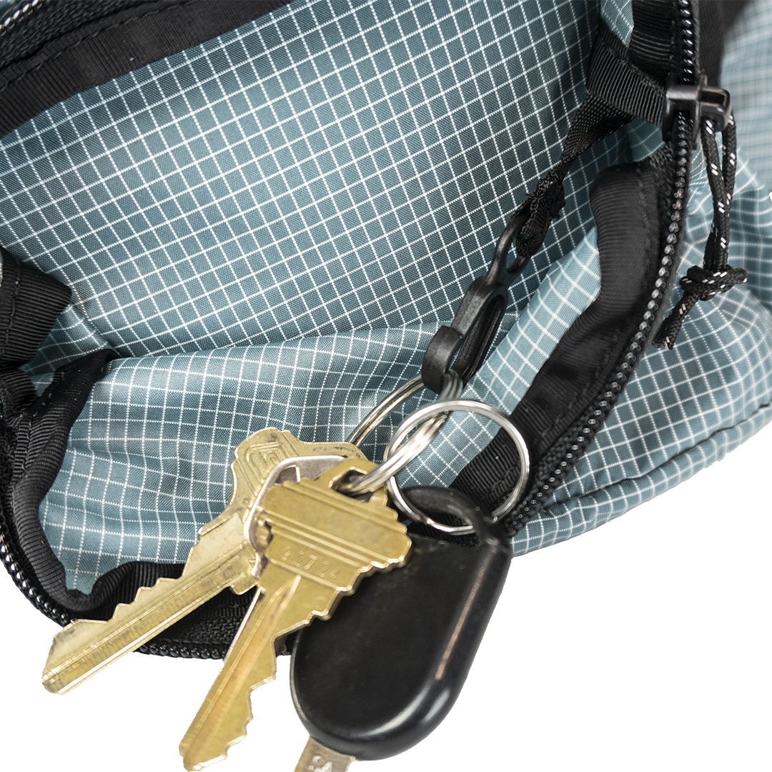 Close-up of the Shadowlight Ultralight Backpack's hip belt pocket with attached key clip