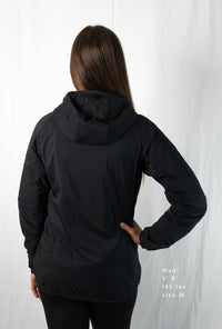 Woman wearing a full zipped hoodie jacket back view