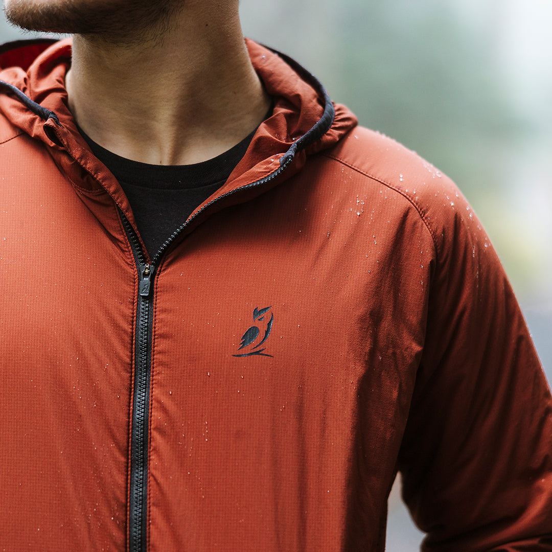 Close-up of water droplets beading on the fabric of a hoodie to show water resistance.