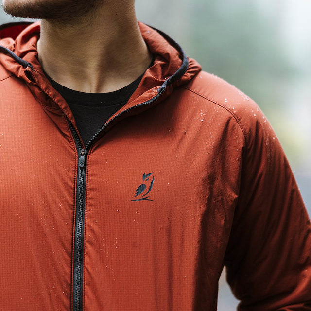 Close-up of water droplets beading on the fabric of a hoodie to show water resistance.