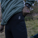 Close-up view of the reflective Outdoor Vitals owl logo on the upper hip of the Highline Thermal Leggings, highlighting the smooth waistband and flatlock seam construction.