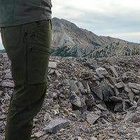 side view of men's hiking pants on rocky mountain peak