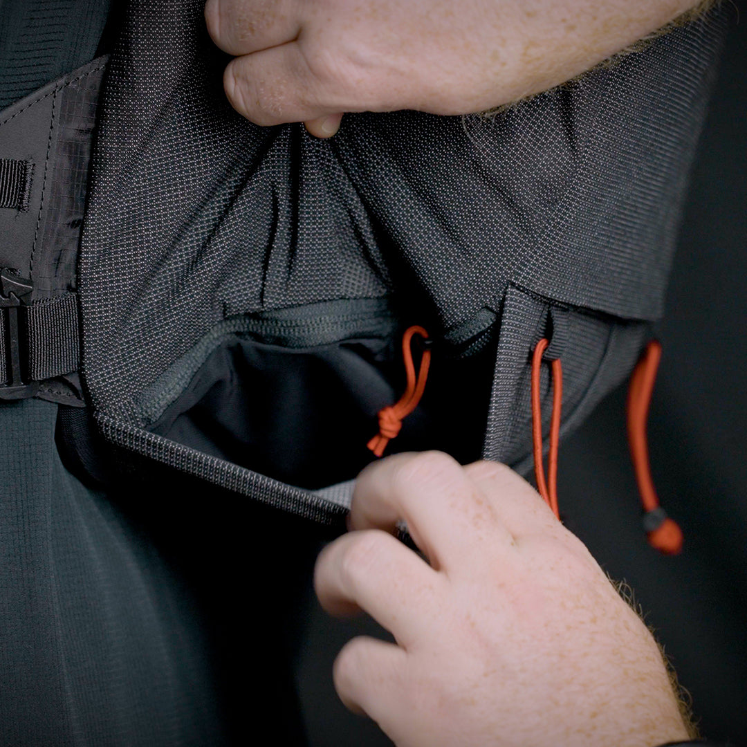 Close-up view of the bottom stretch mesh pocket on the Outdoor Vitals Skyline 30 Fastpack.