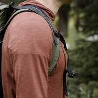 Close-up of a backpack strap over Outdoor Vitals merino hoodie.