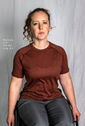 A woman modeling a extra small Tern Ultralight Merino Wool Tee with fit details listed
