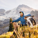 Hiker wearing a Ventus Active Hoodie resting on a mountain with a backpack.