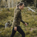 Woman in an hooded jacket and black leggings walking on an outdoor trail.