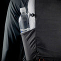 Close-up side view of the Outdoor Vitals Skyline 30 Fastpack showing a water bottle stored in the side stretch-woven pocket with cinch adjustment for secure carry.