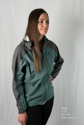 Fit-reference studio shot of a female model wearing a Tushar Rain Jacket in a men's size small.