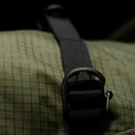 Close-up of a textured bag with a black strap and buckle.
