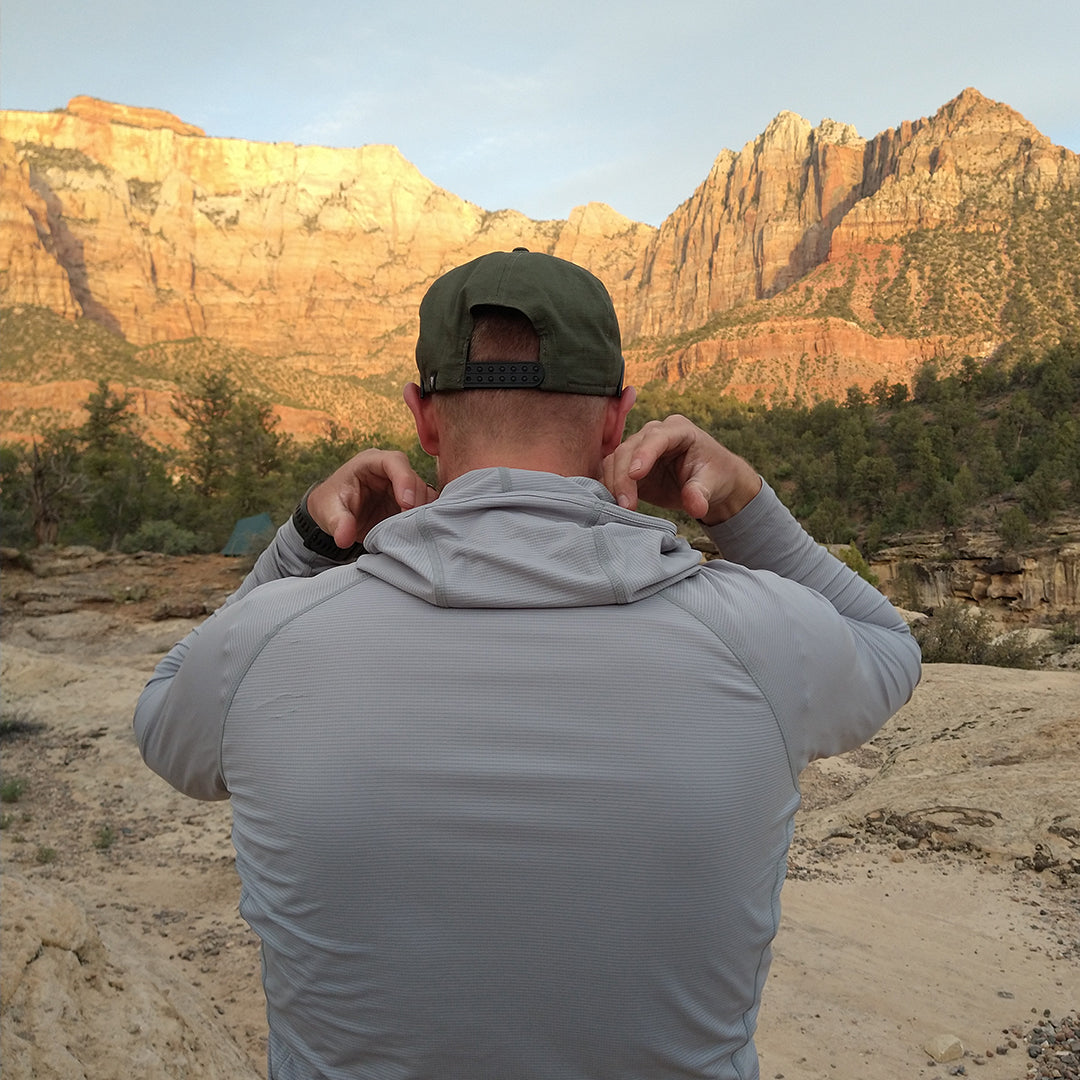 Gray - Man wearing the Altitude Sun Hoodie in front of the mountain