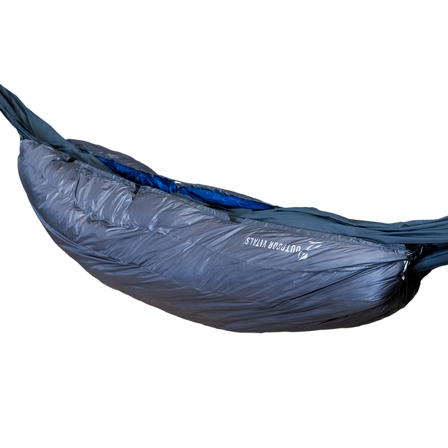 Side profile view of the Outdoor Vitals StormLoft 0°-30°F Down UnderQuilt attached beneath a hammock, highlighting the brand logo and draft baffles.