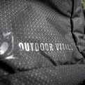 Extreme close-up of the Outdoor Vitals logo and brand name printed on the durable grid-patterned ripstop fabric of the KotaUL Ultralight Travel & Adventure Backpack.