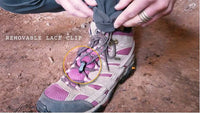 Close-up of the bottom hem of Outdoor Vitals Satu Adventure Pants, highlighting the removable lace clip feature secured to a hiking boot's laces.