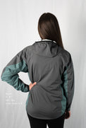Back view fit-reference studio shot of a model wearing a Tushar Rain Jacket in a men's size small.