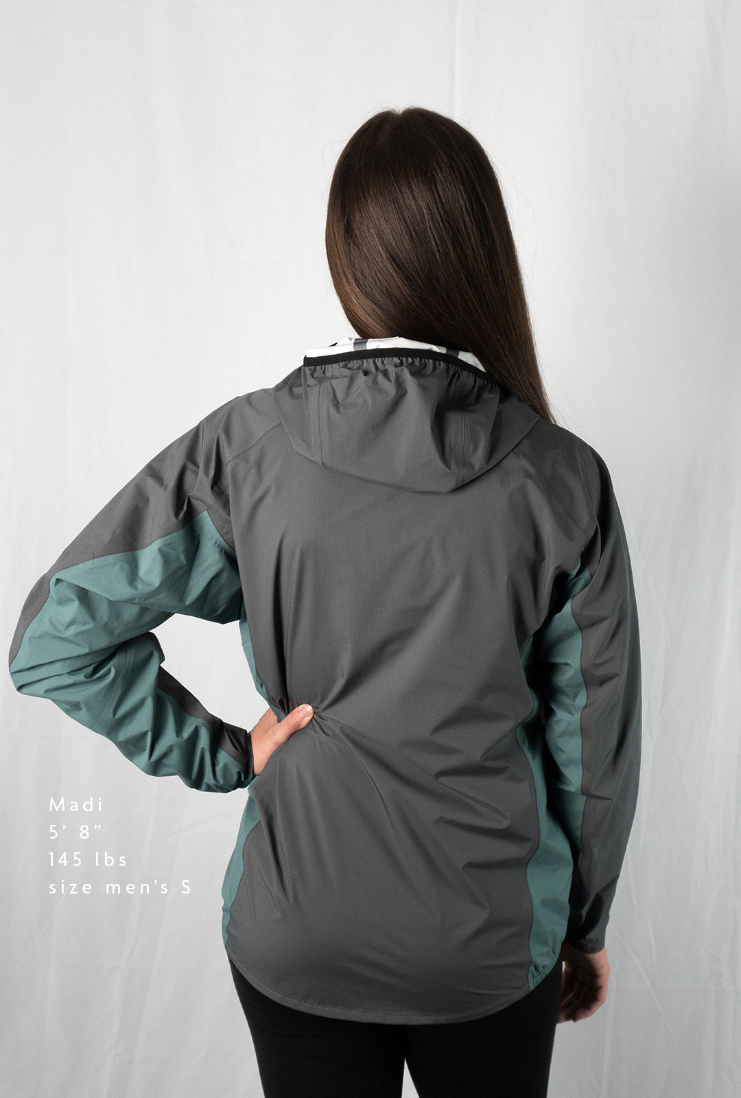 Back view fit-reference studio shot of a model wearing a Tushar Rain Jacket in a men's size small.