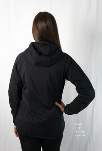 Woman wearing a full zipped hoodie jacket back view