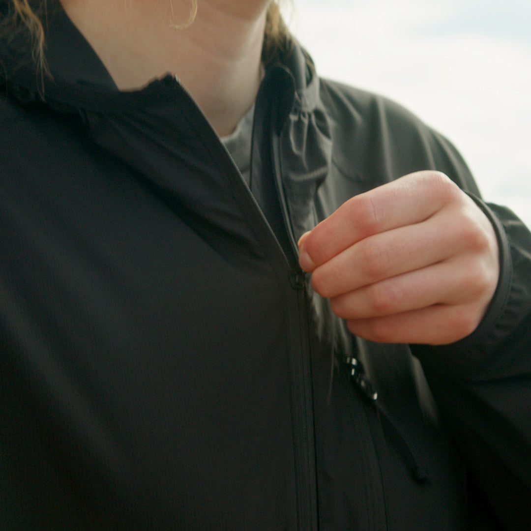 Zipping up the Nebo Windbreaker front pocket