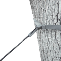 Close-up of an Outdoor Vitals tree saver strap wrapped around a tree trunk and attached to a Whoopie Sling suspension line.