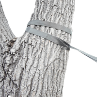 Close-up of an Outdoor Vitals tree saver strap wrapped around a tree trunk as part of a hammock suspension system.