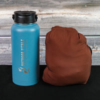 Packed Outdoor Vitals Vario Jacket beside a water bottle for size comparison